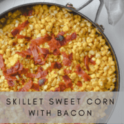Sweet corn topped with bacon in a skillet.