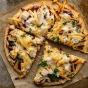 Overhead shot of BBQ Chicken Pizza cut into four pieces.