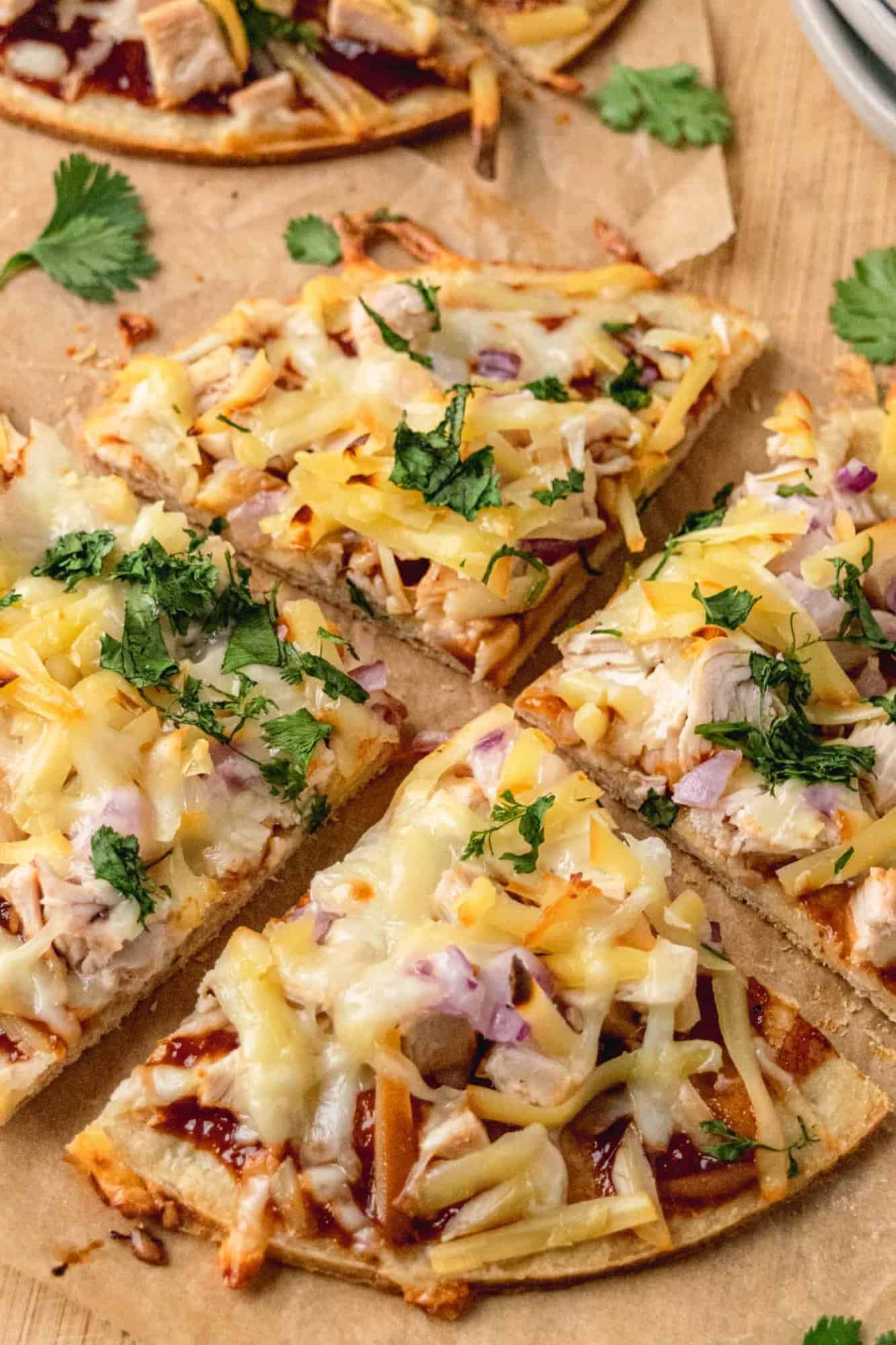 BBQ Chicken Pizza sliced into four pieces.