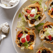 Overhead shot of Double Layer Beef Taco Cups on a white plate.