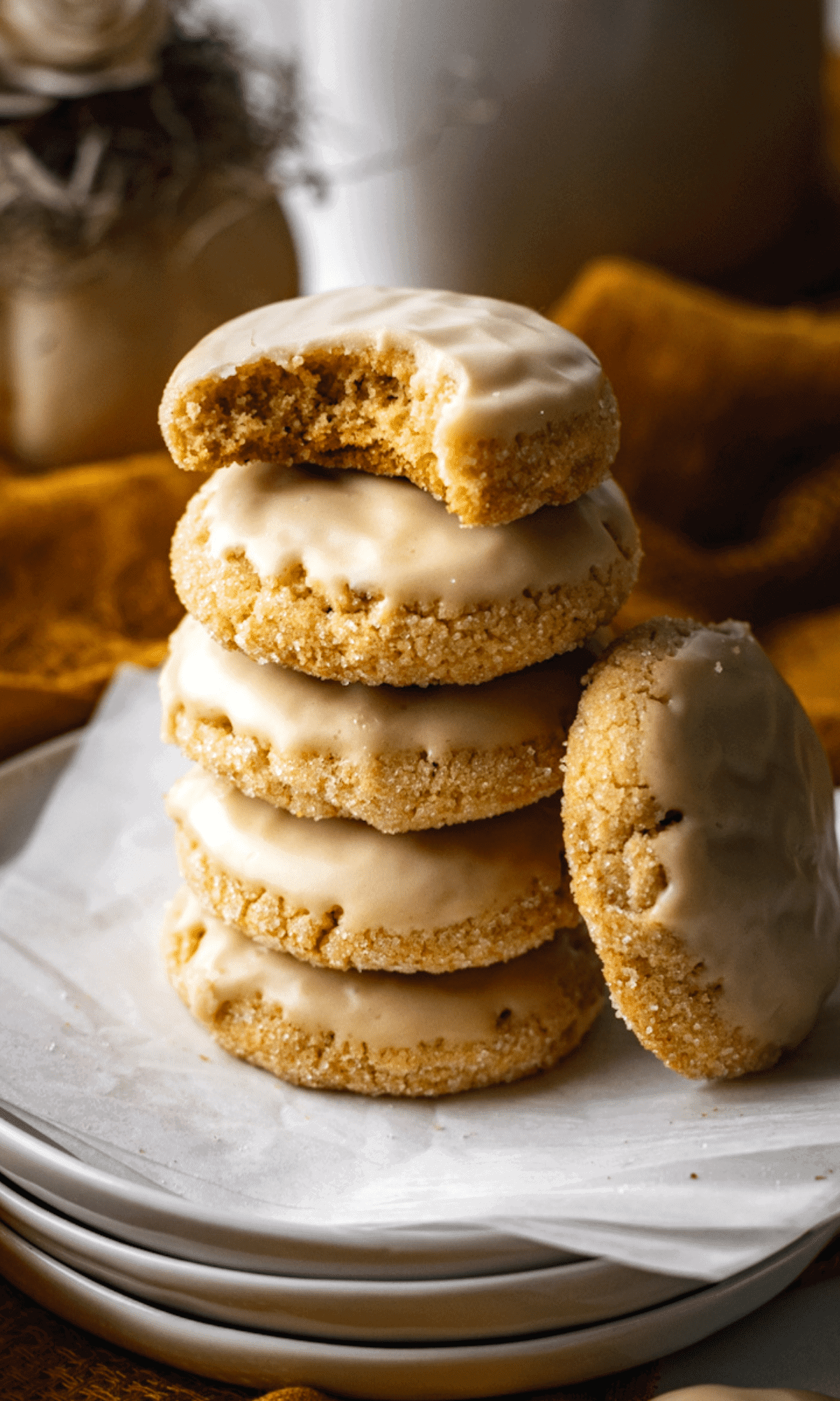 A stack of five cookies on a white plate.