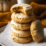 A stack of five brown butter brown sugar maple glazed cookies with one cookie leaning up on it's side.