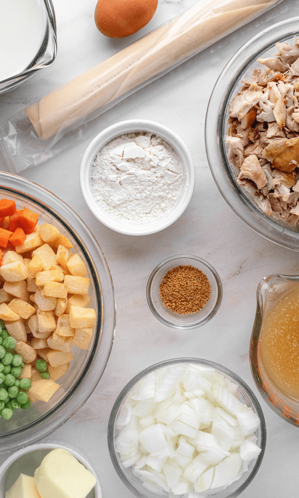 Overhead shot of Mini Dutch Oven Chicken Pot Pie ingredients in varying bowl shapes and sizes.