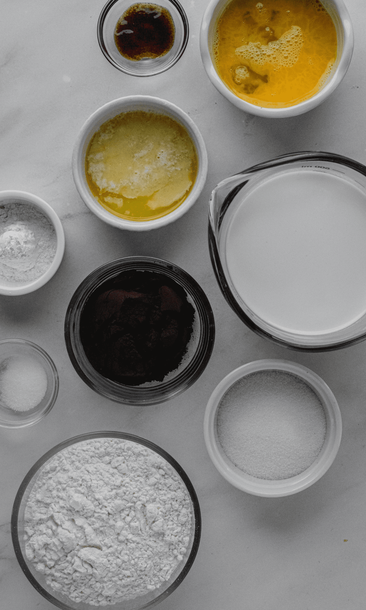 Ingredients for Cocoa Buttermilk Pancakes in varying bowl shapes and sizes.
