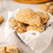 Cheese and Onion Scones in a bowl lined with a white cloth napkin.