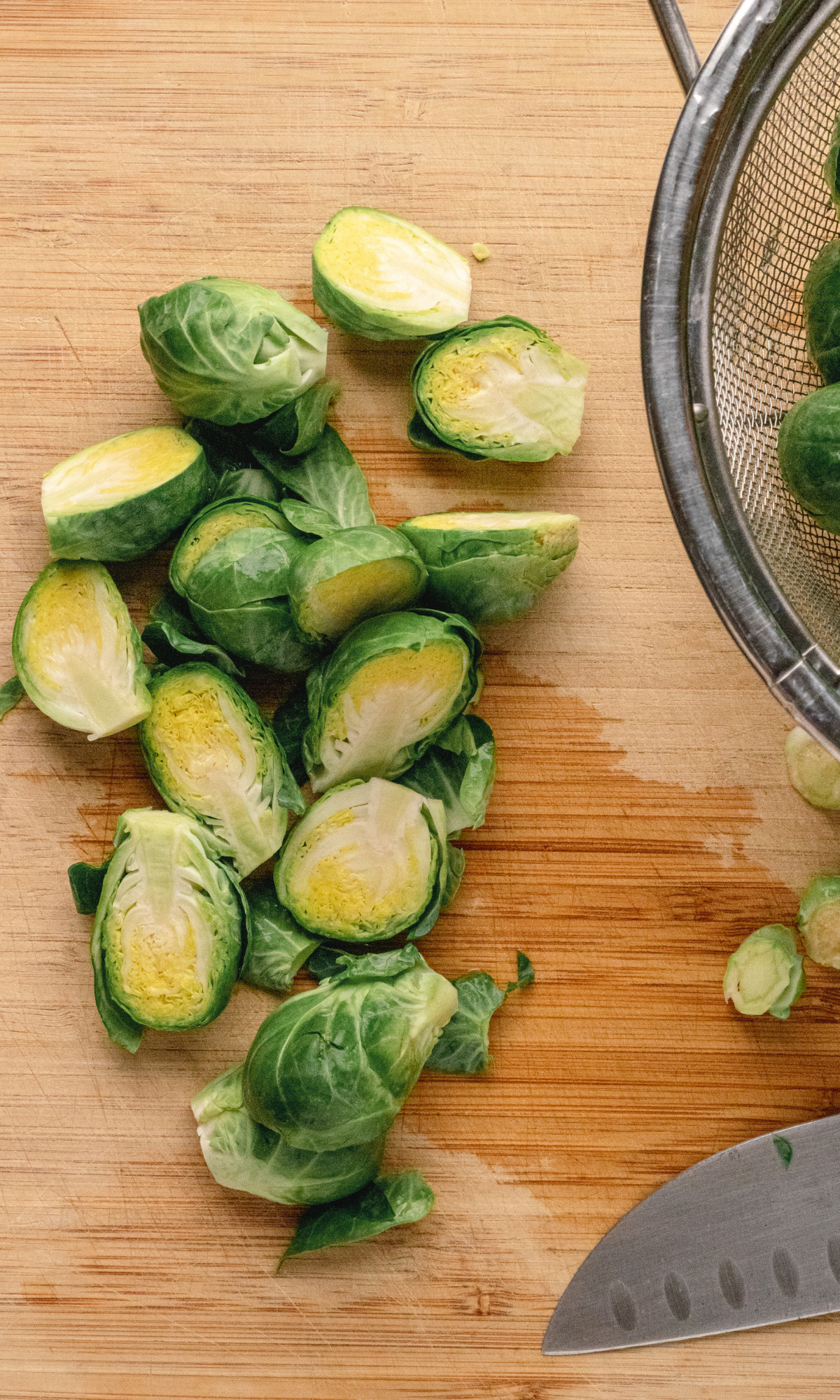 Overhead shot of sliced Brussels sprouts on a cutting board.