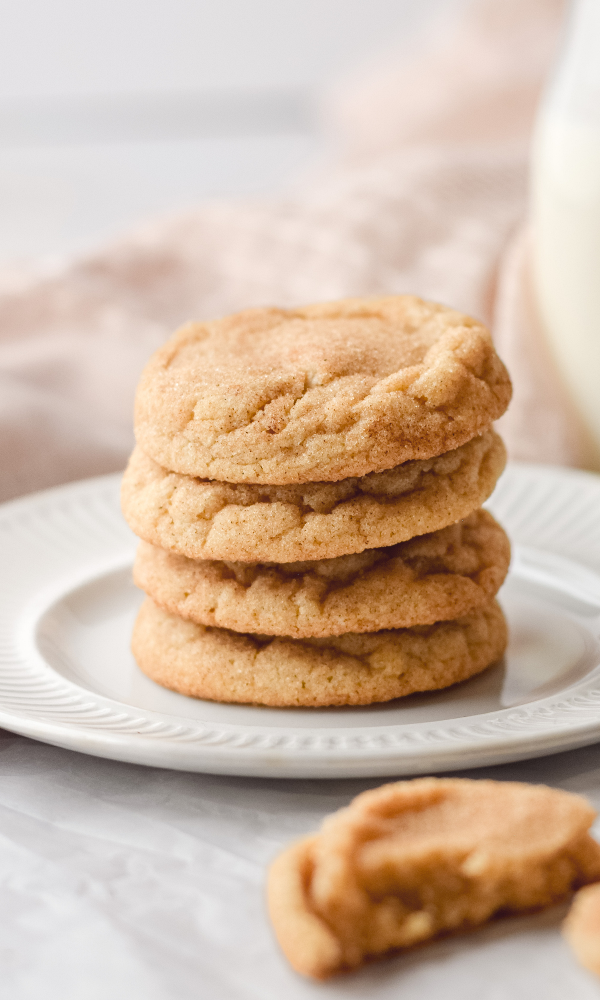 Straight on shot of a stack of snickerdoodle cookies on a white plate.