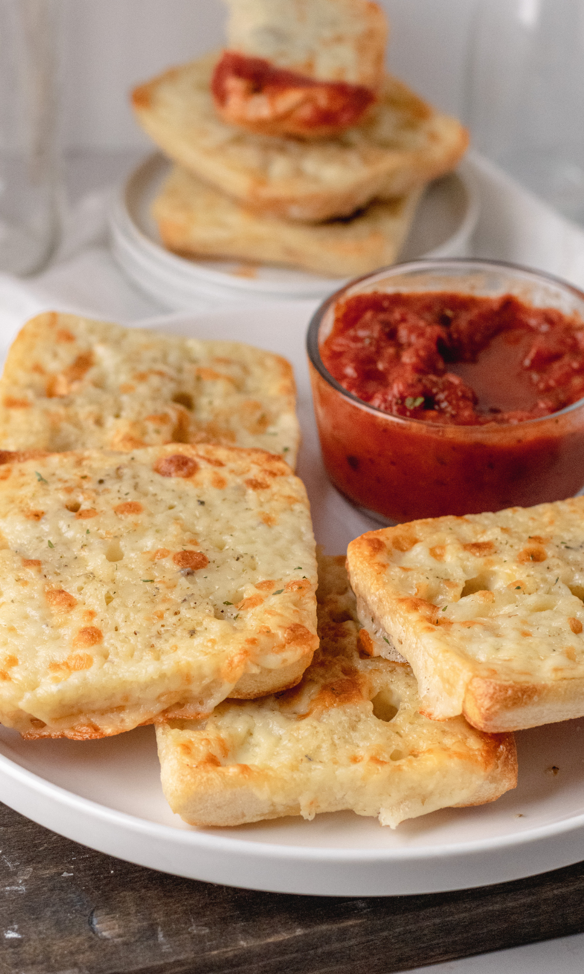 Italian Dunkers on a white plate with marinara dipping sauce.