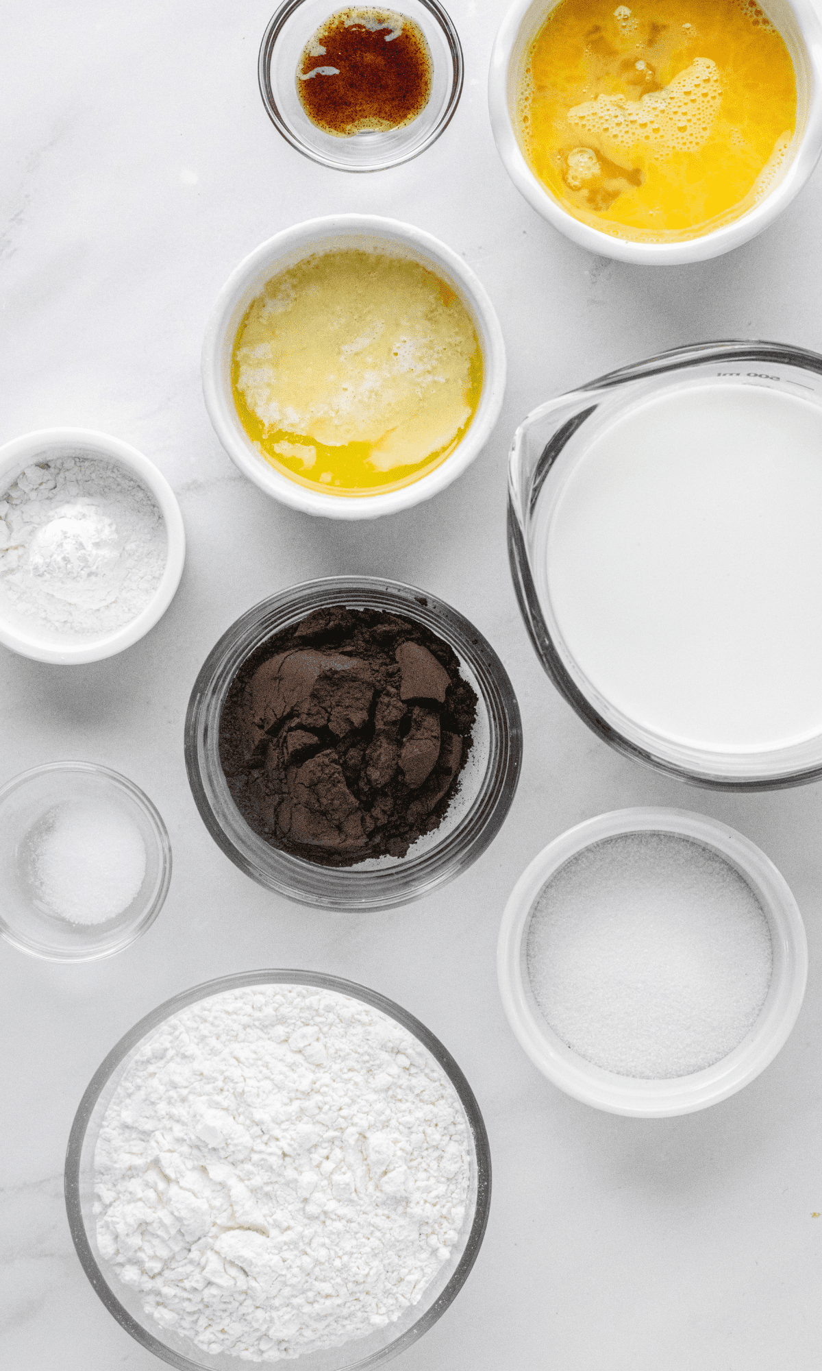 Ingredients for Chocolate Buttermilk Pancakes in varying bowl shapes and sizes.