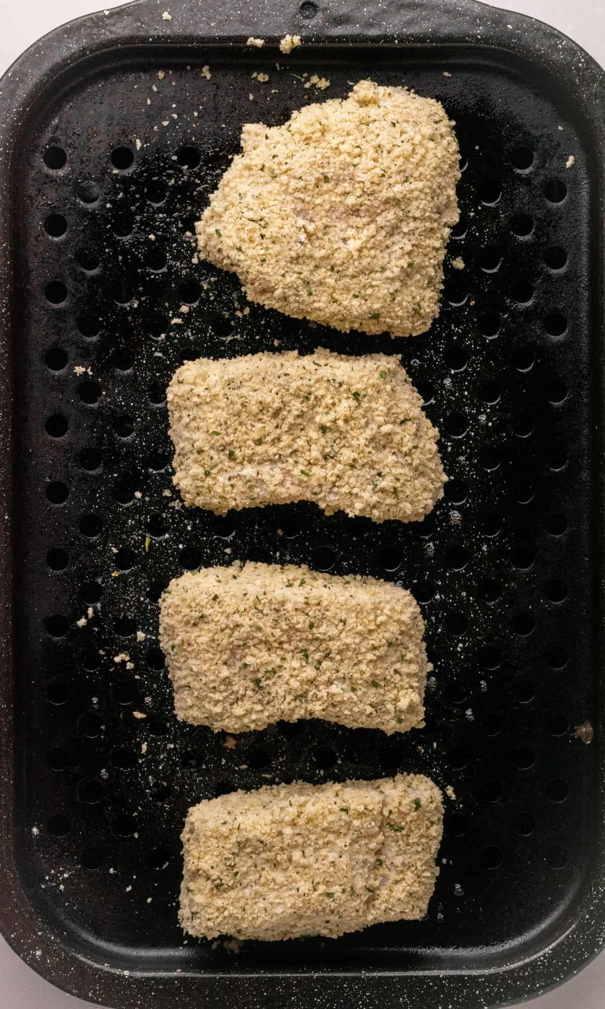 Crunchy Baked Cod with Parmesan Panko Breadcrumbs on broiler pan before baking.