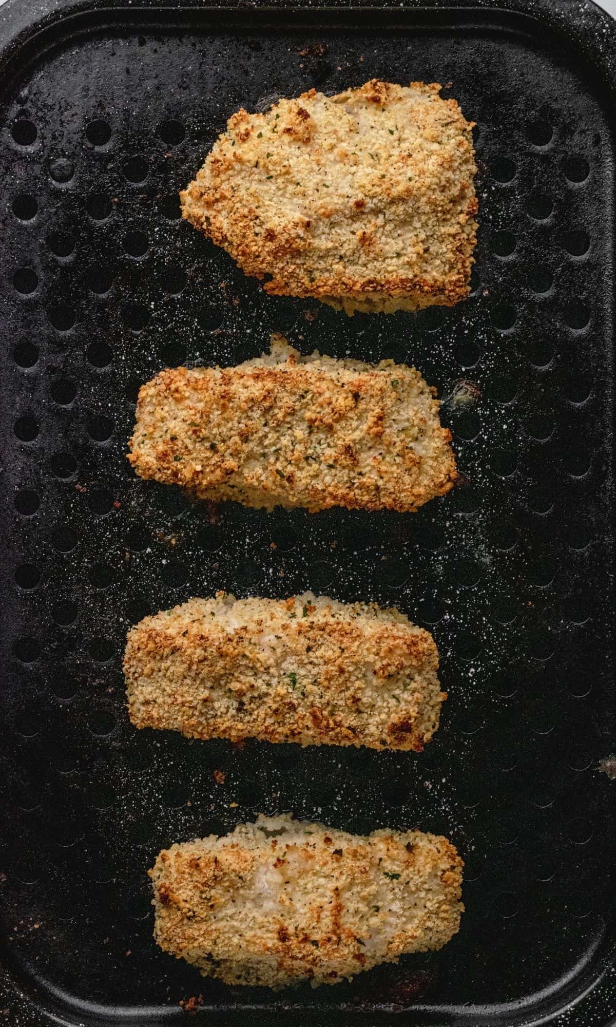Crunchy Baked Cod with Parmesan Panko Breadcrumbs on broiler pan after baking.