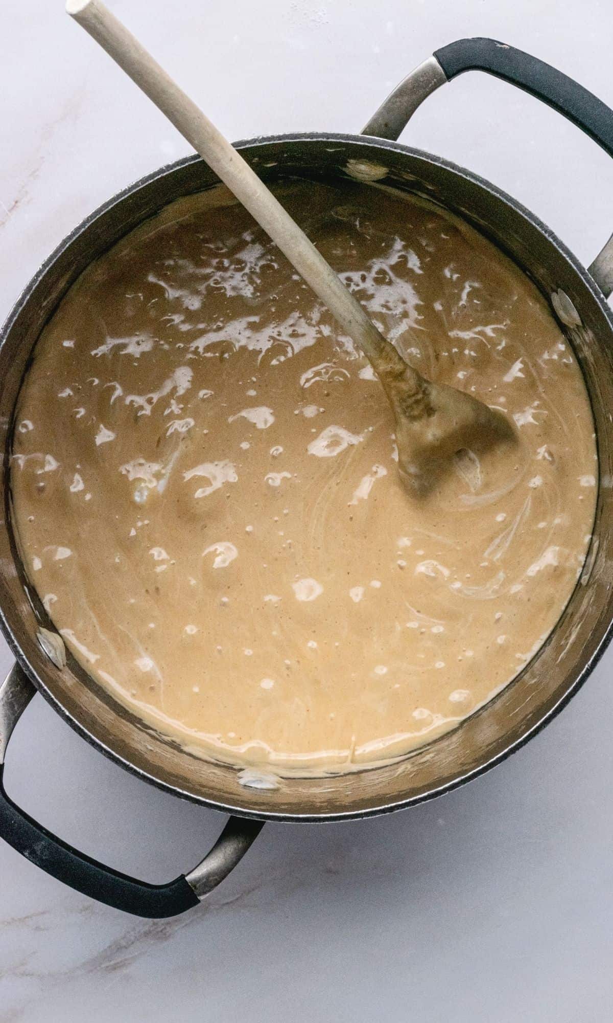 Overhead shot of melted marshmallows and peanut butter in a large saucepan.