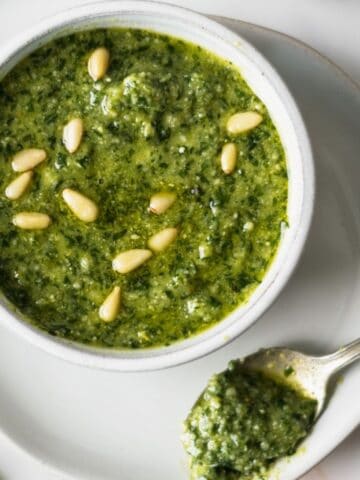 Overhead shot of a bowl of pesto in a white bowl.