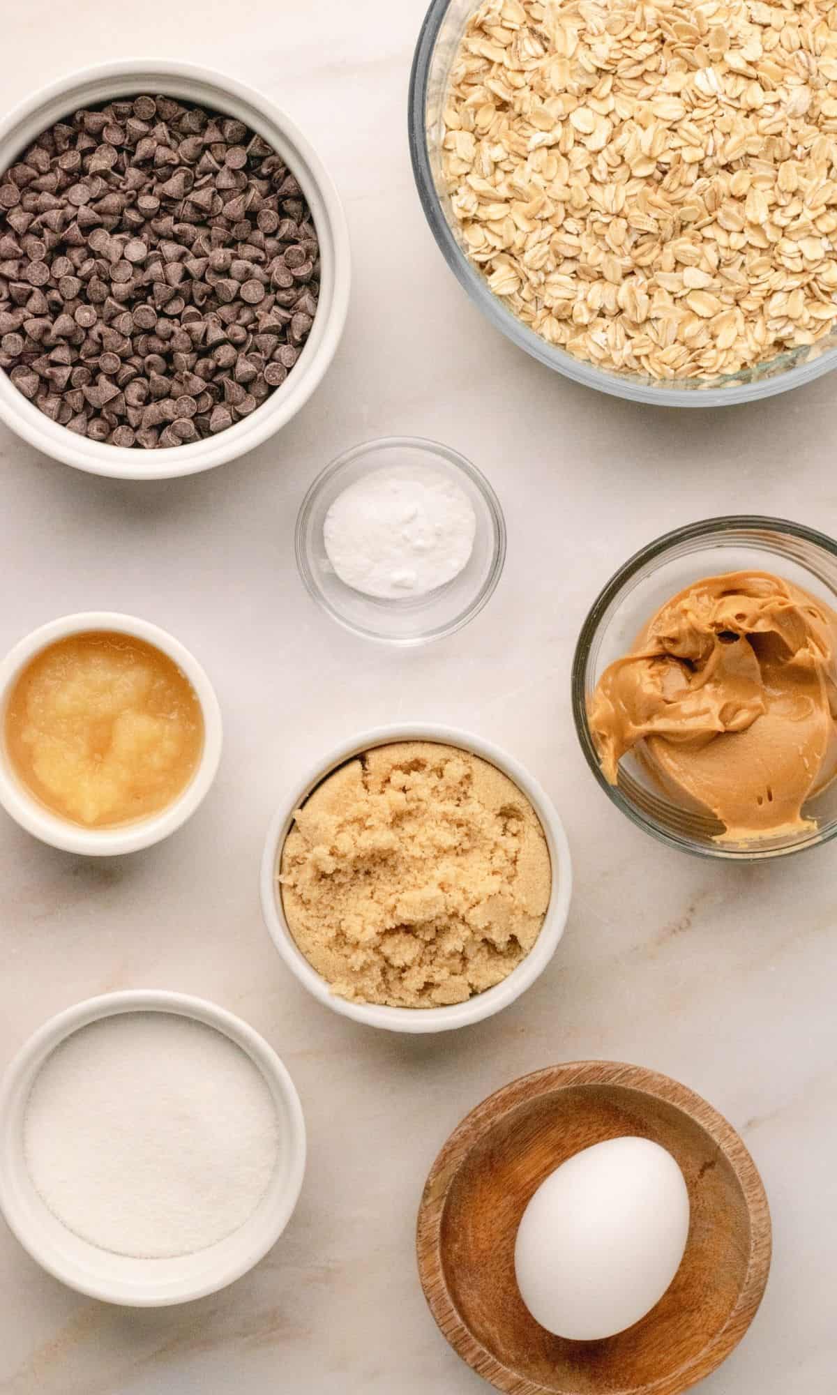 Peanut butter chocolate chip cookie ingredients in varying bowl shapes and sizes.