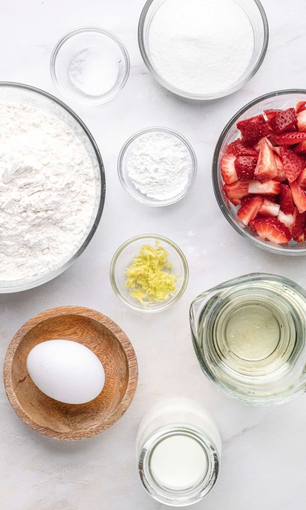 Strawberry lemon muffin ingredients in varying bowl shapes and sizes.