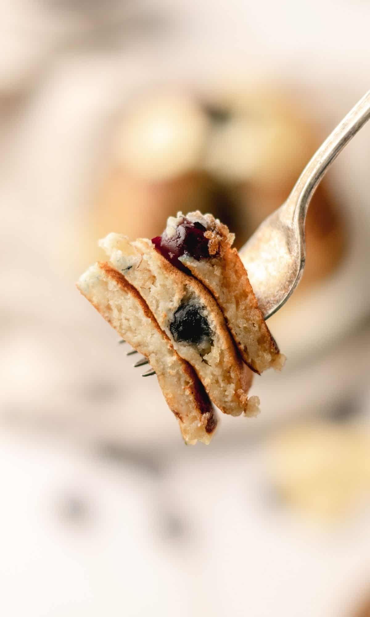 A bite of Banana Blueberry Buttermilk Pancakes on a fork.