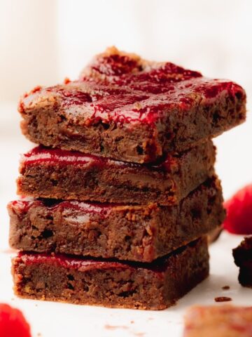 A stack of four chocolate raspberry brownies.