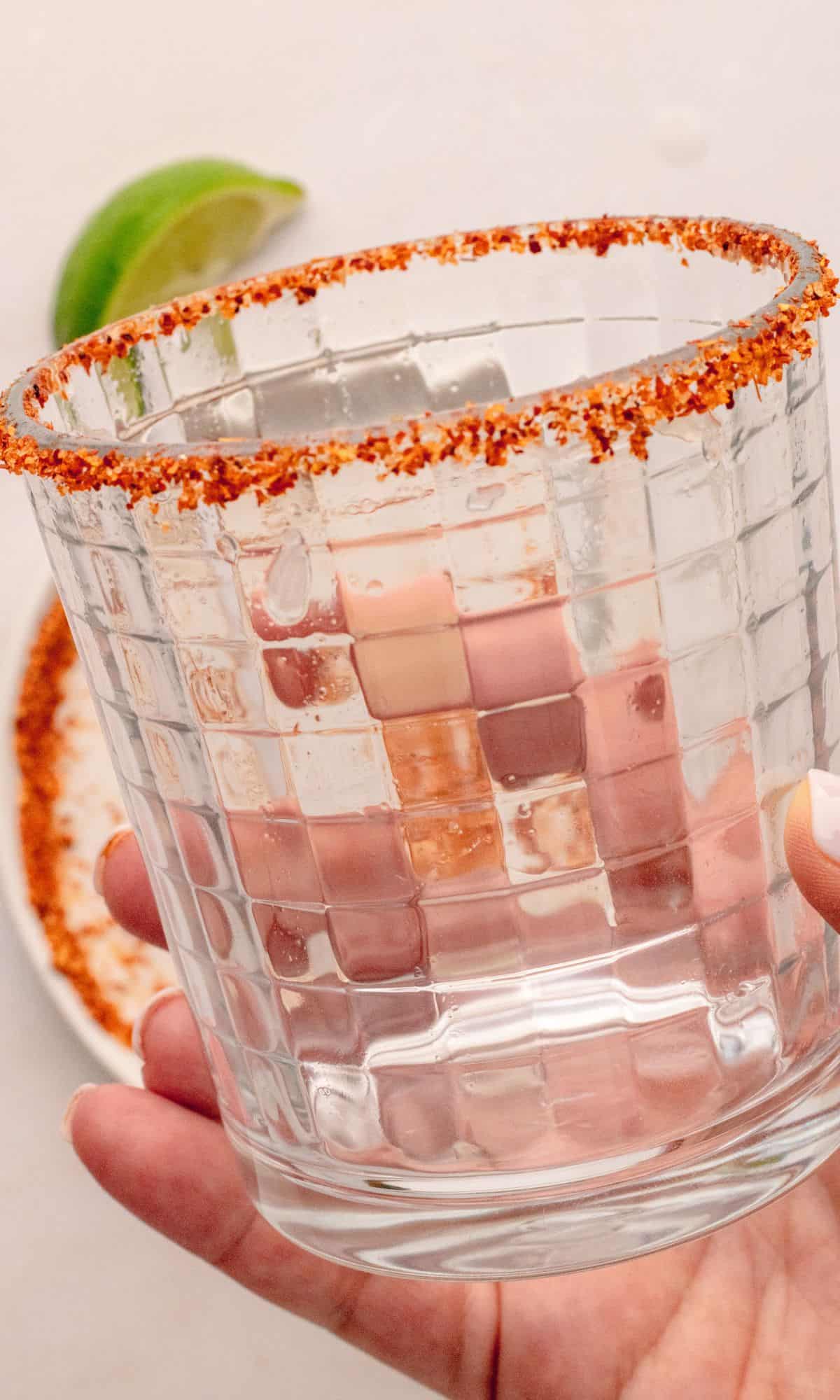 A glass lined with chili lime seasoning.