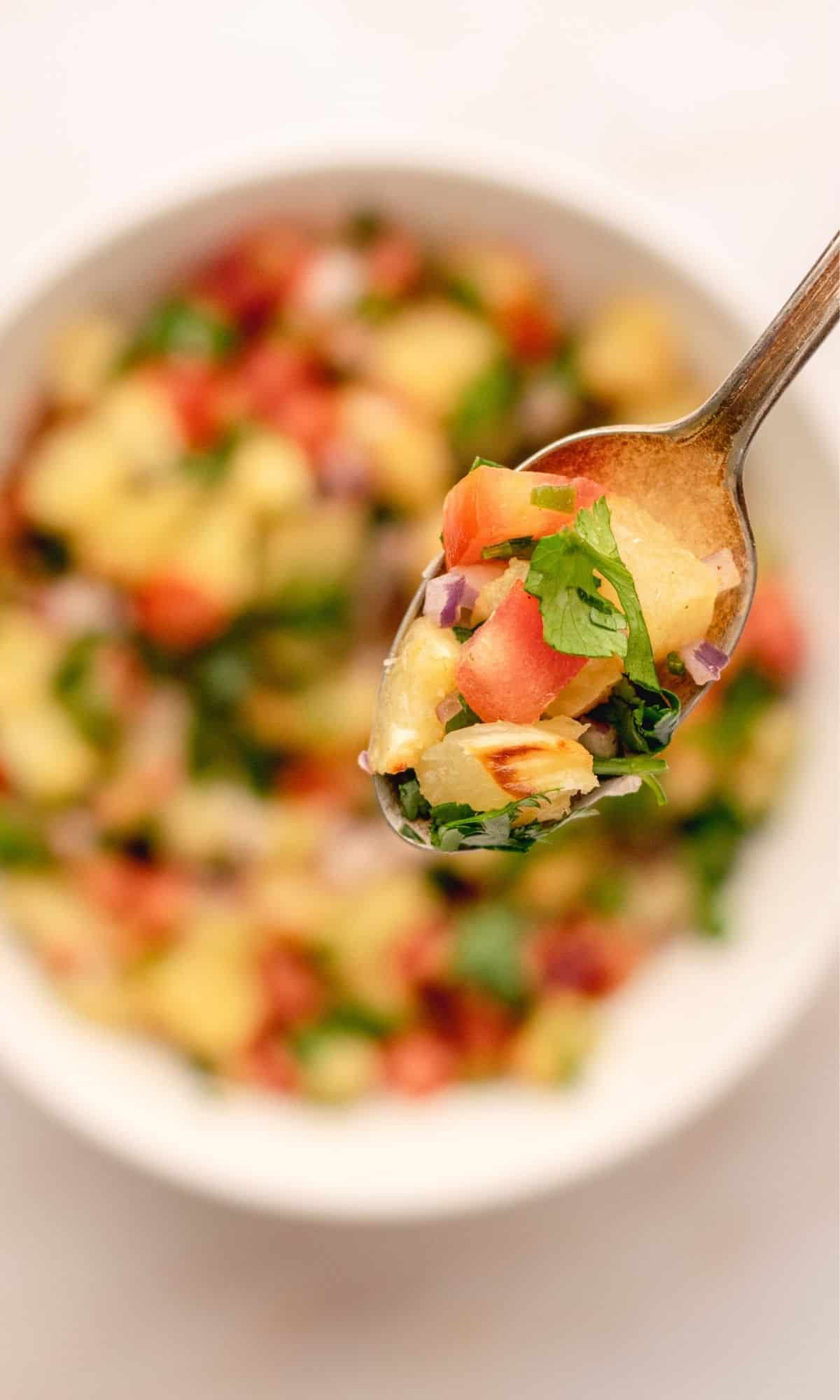 Roasted pineapple salsa in a white bowl.