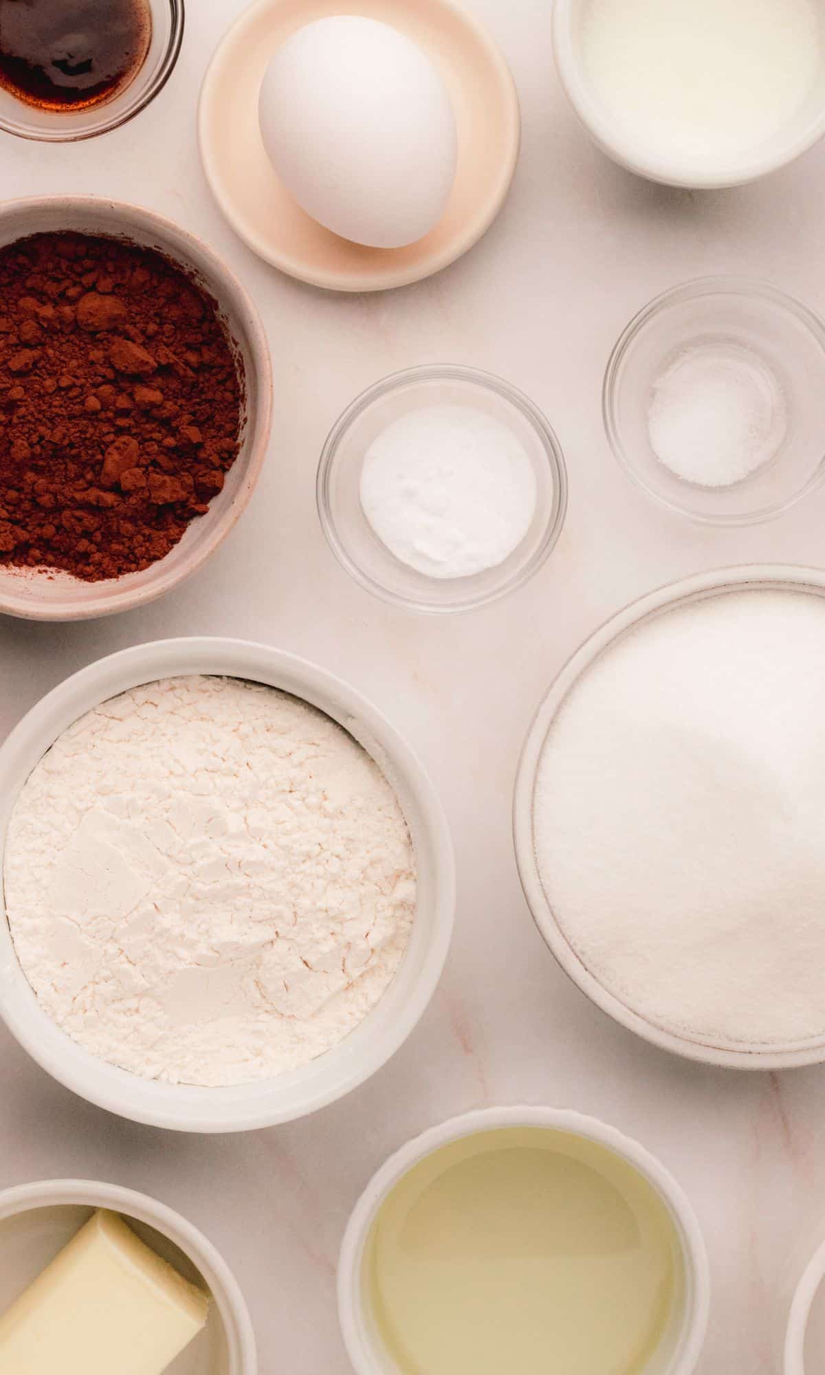 Chocolate cupcake ingredients in varying bowl shapes and sizes.