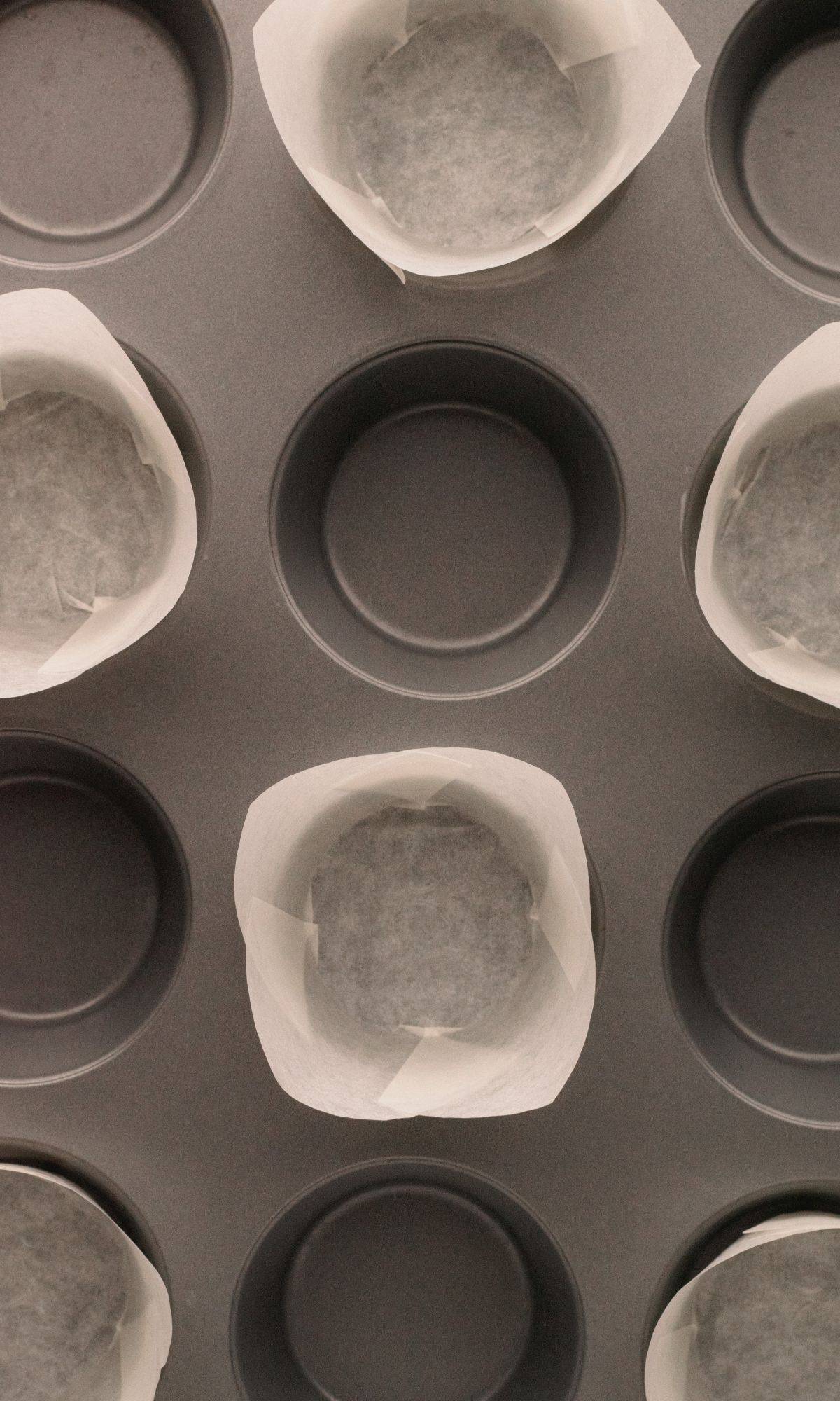 A muffin tin with muffin liners in everyother hole.