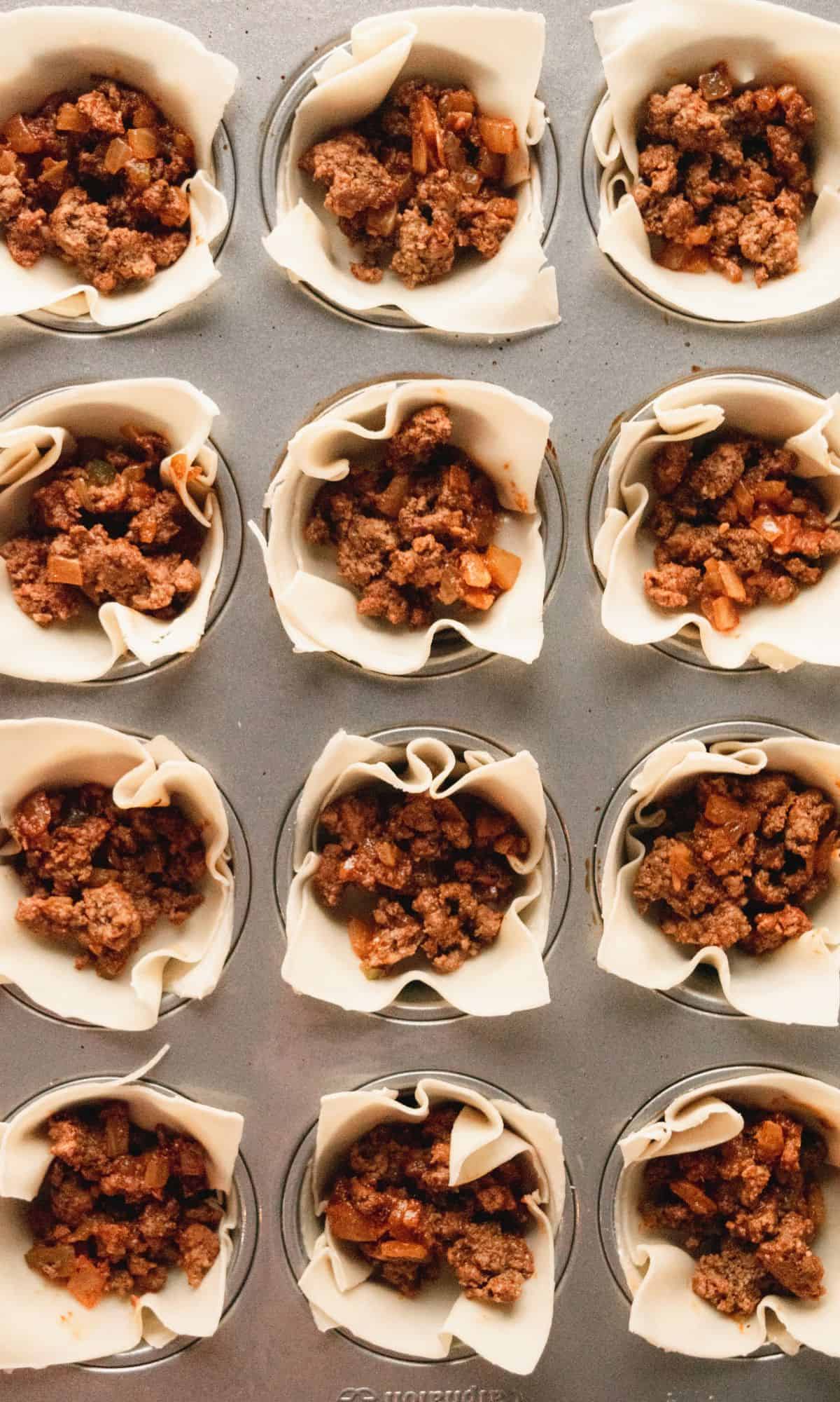 Taco cup preparation in muffin tin.