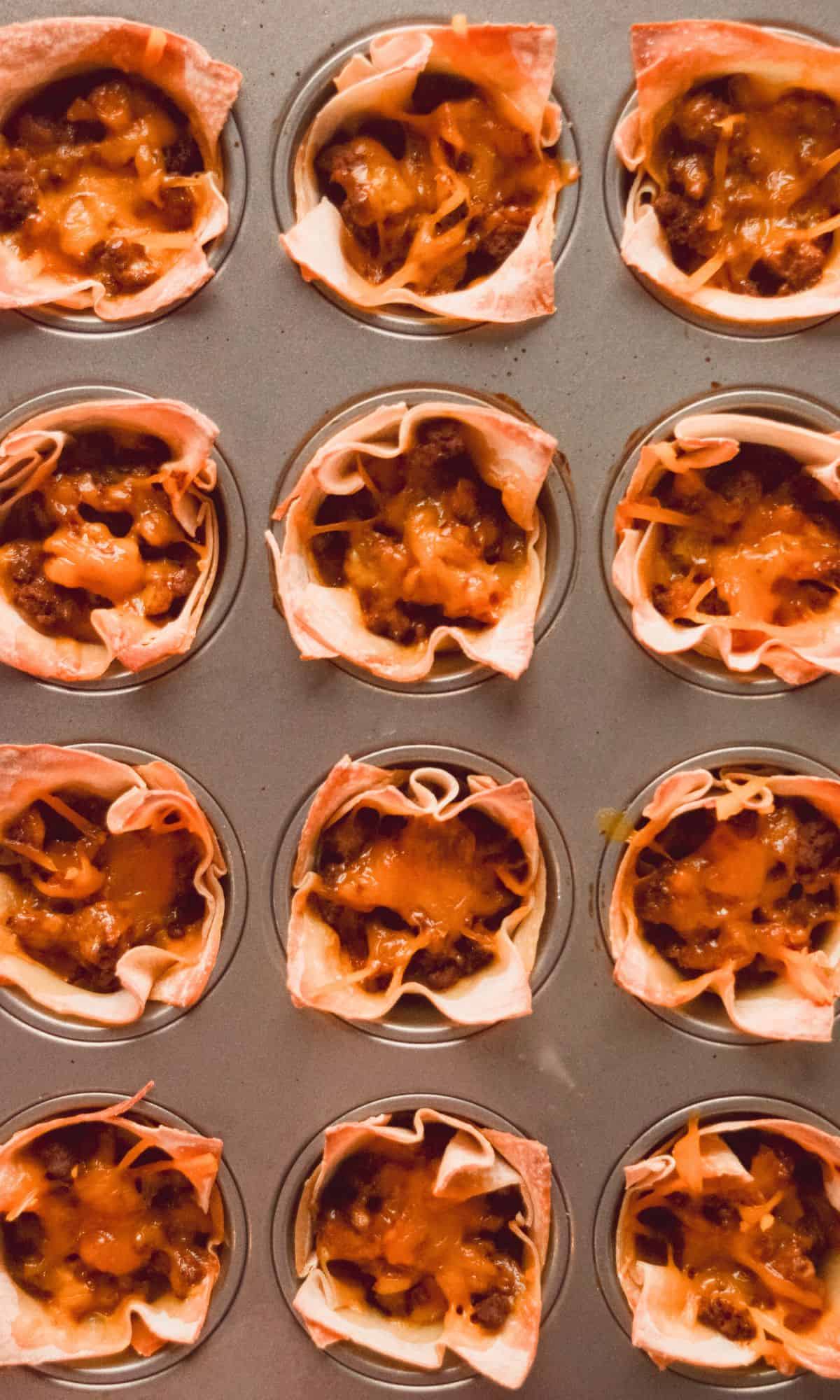 Baked taco cup preparation in muffin tin.