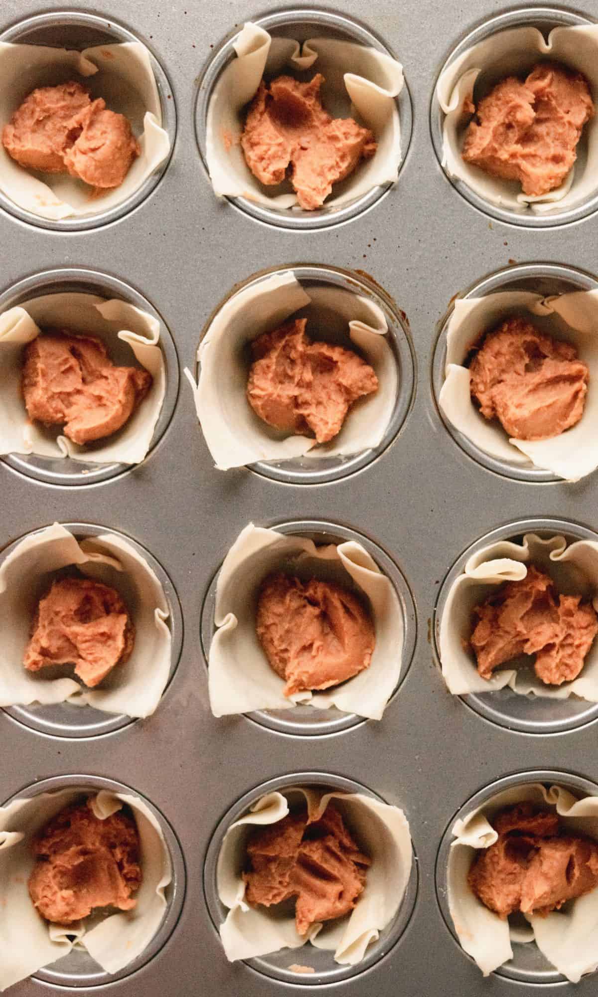 Taco cup preparation in muffin tin.