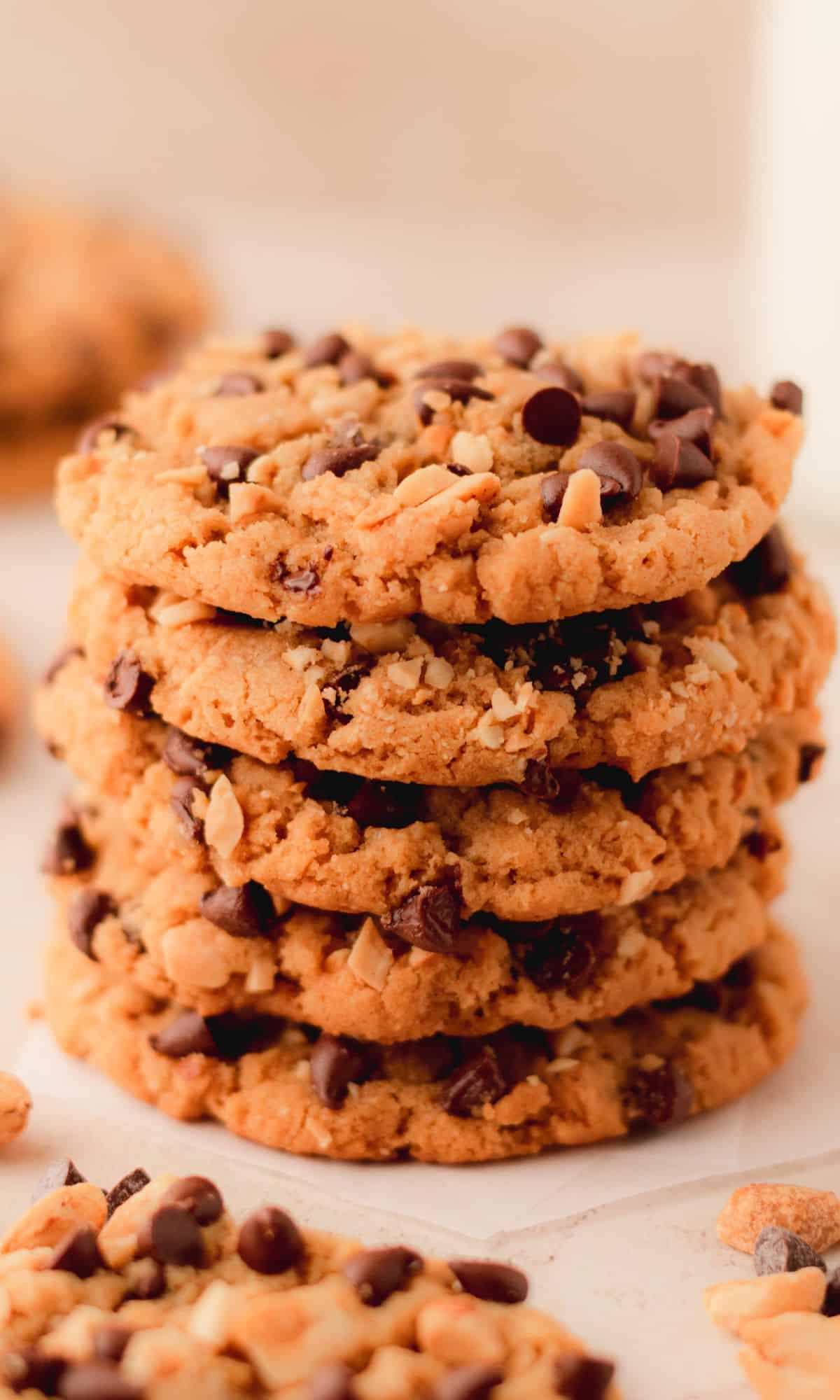 A stack of five peanut butter cookies with chocolate chips.