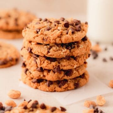 A stack of five peanut butter cookies with chocolate chips.