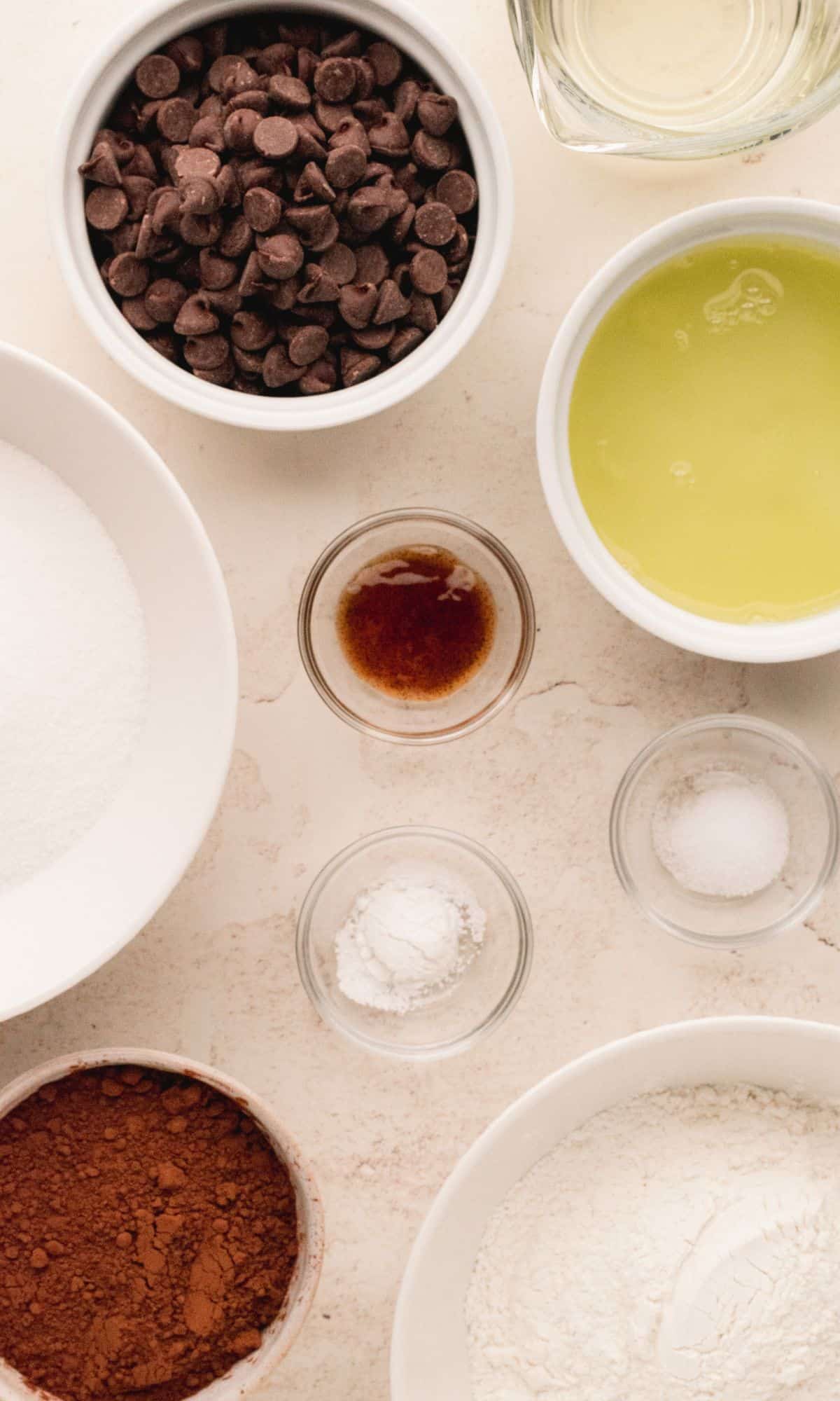 Brownie cookie ingredients in varying bowl shapes and sizes.