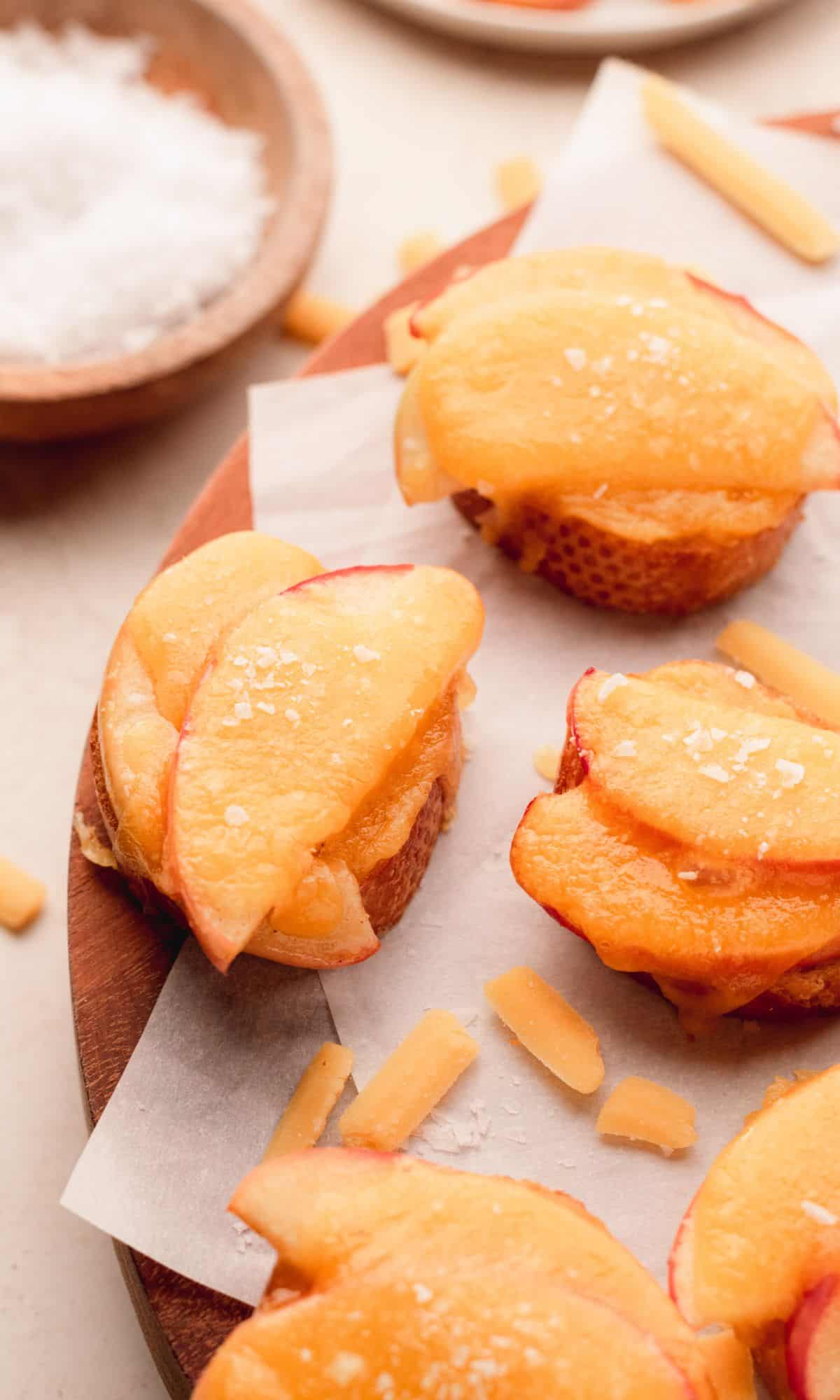 Bread topped with apple slices and melted cheese.