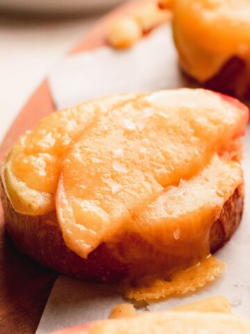 Crostini with apple slices and melted cheddar cheese.