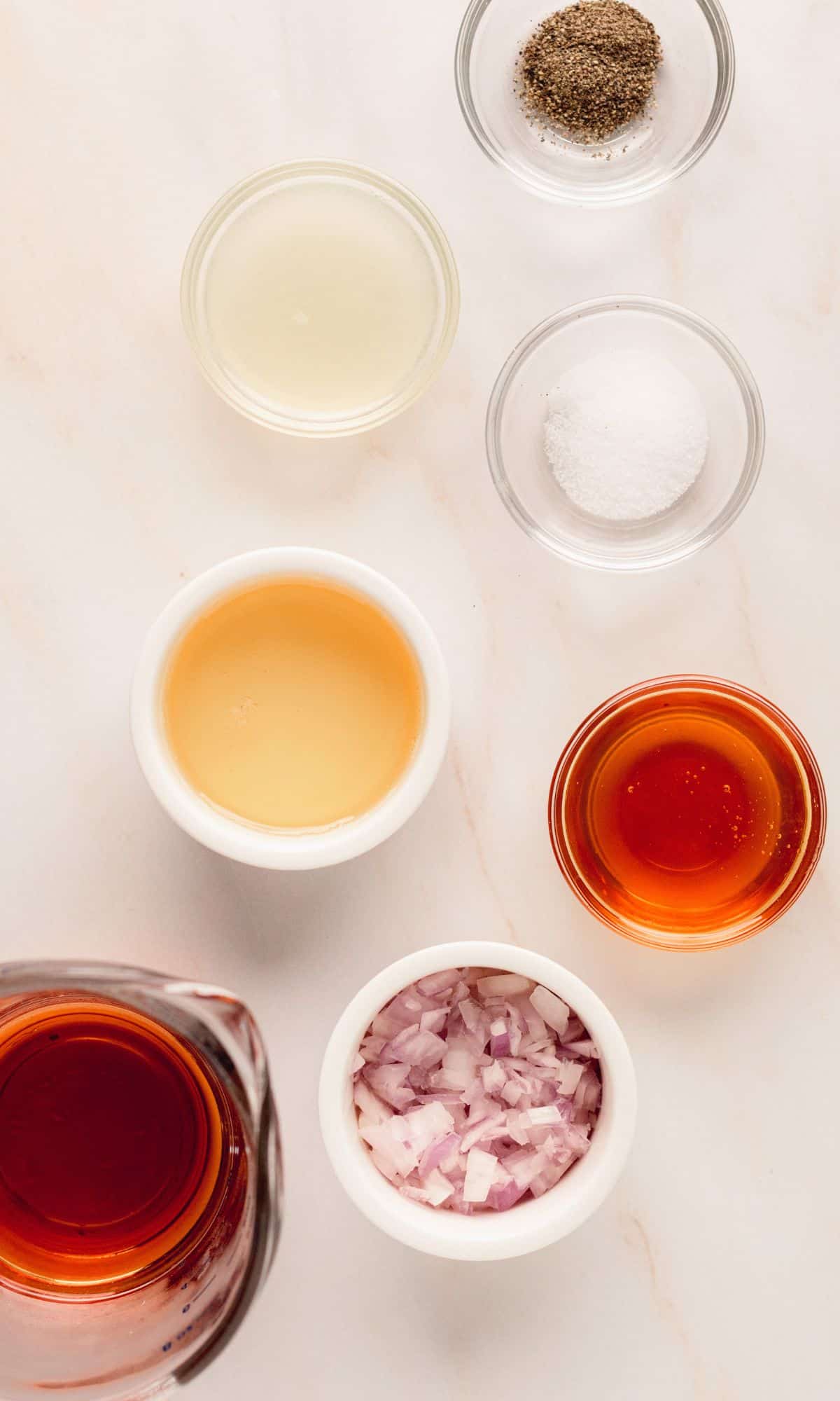 Pear salad dressing ingredients in varying bowl shapes and sizes.