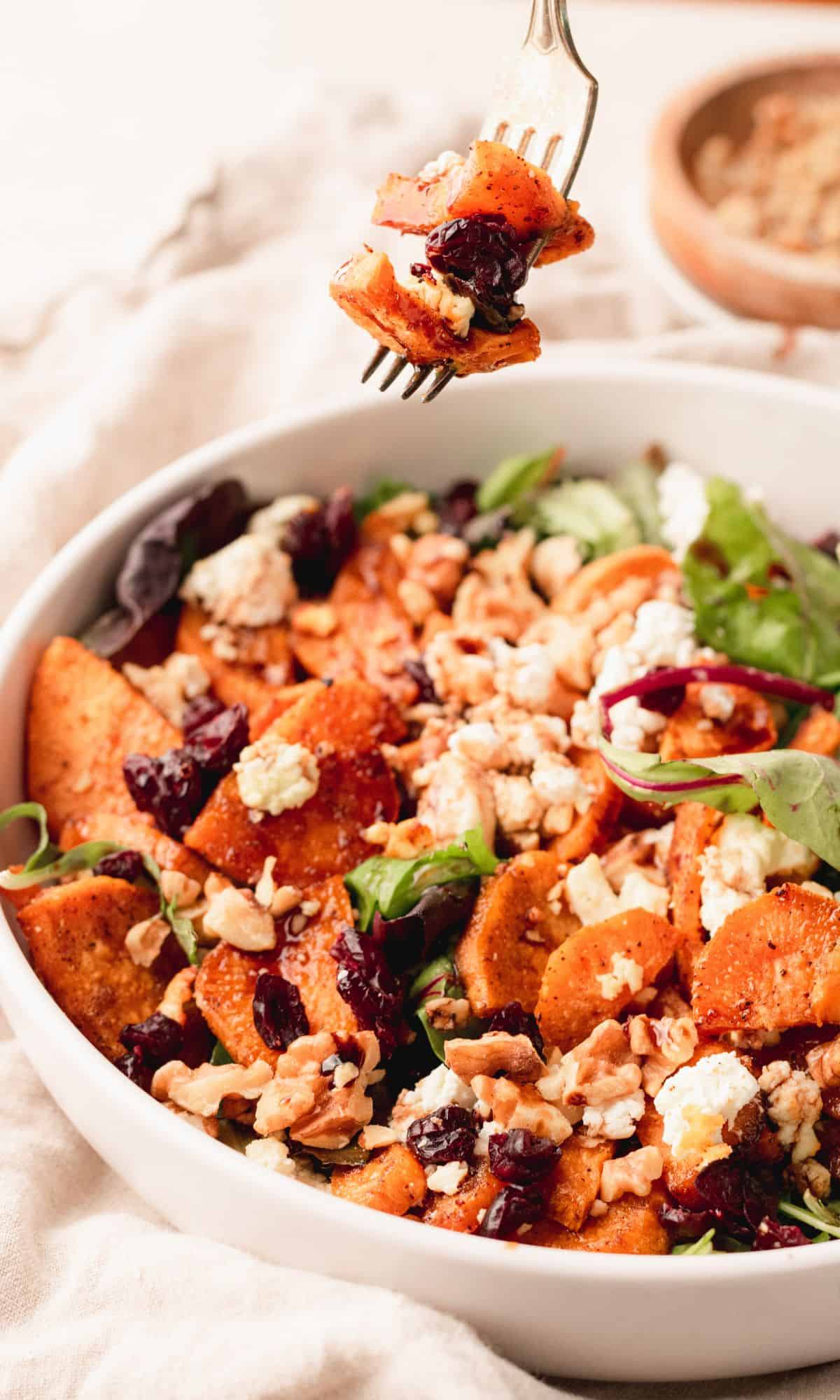 Roasted sweet potato salad in a white bowl.