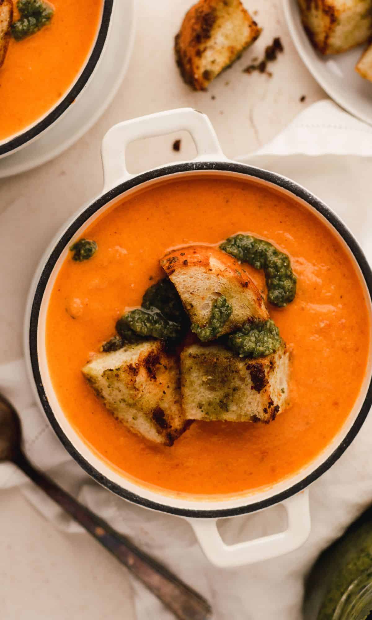 Roasted tomato soup in mini Dutch ovens topped with pesto croutons.