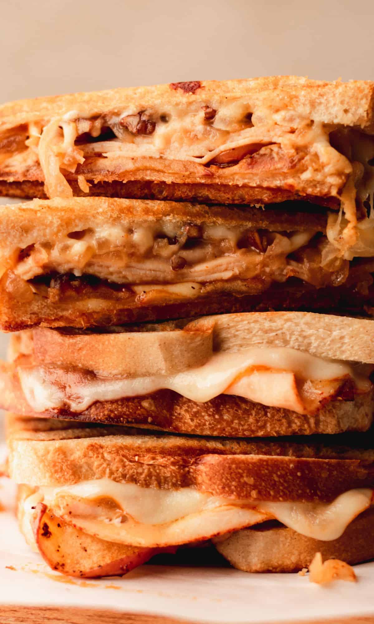 A stack of roasted apple and chicken panini halves.