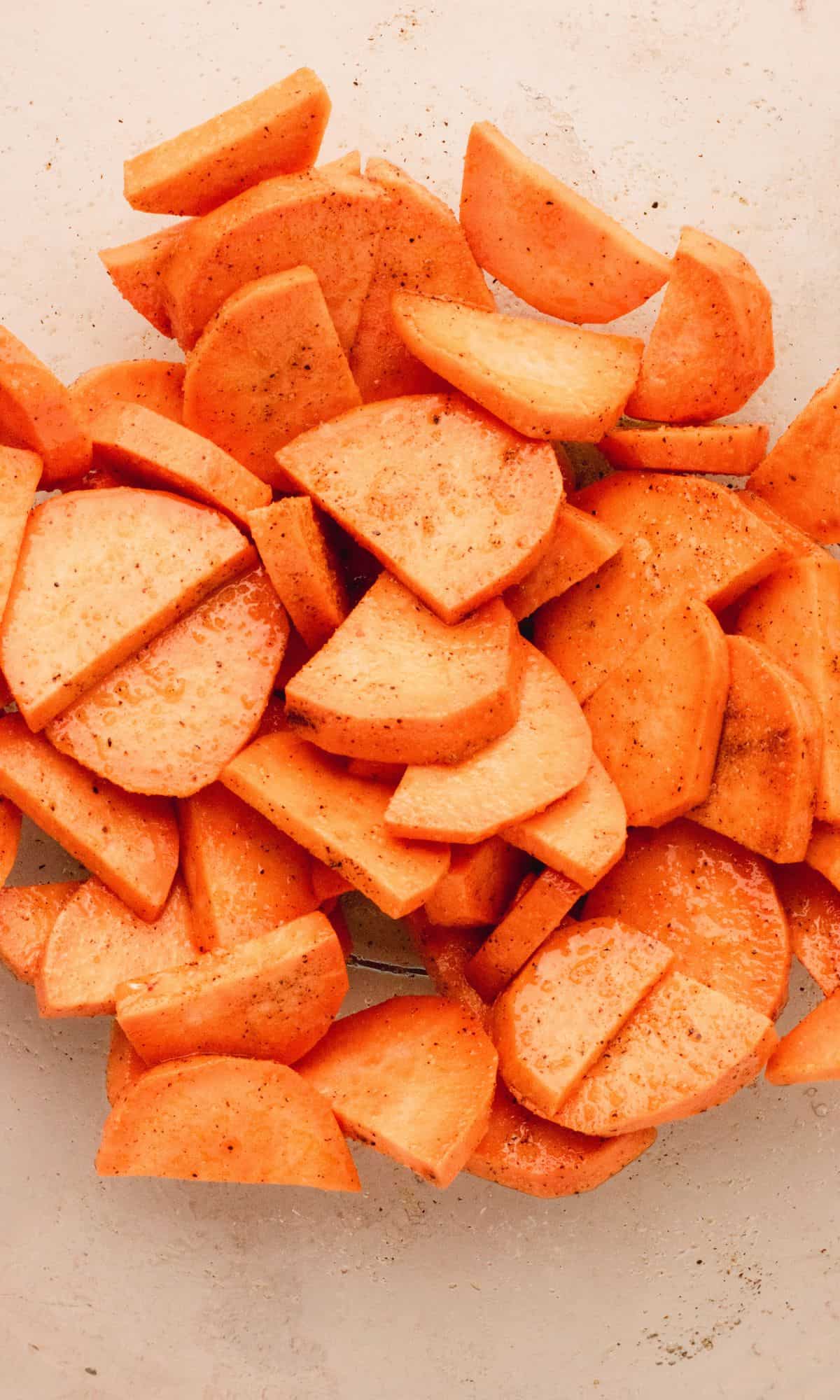 Sliced sweet potatoes in a glass bowl.
