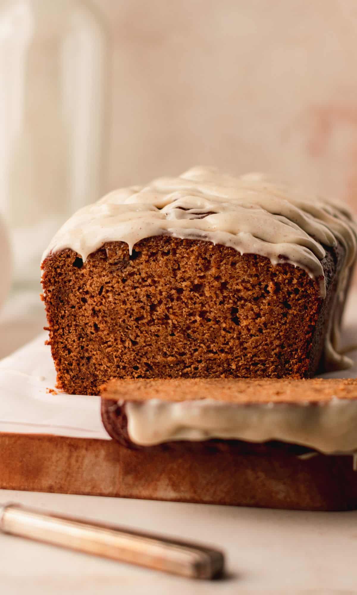 A loaf of pumpkin banana bread with brown butter glaze on top.