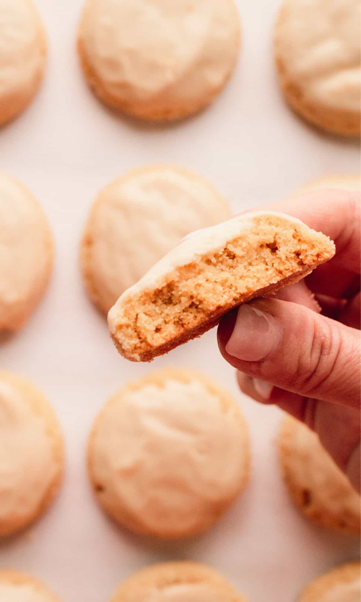 A brown butter brown sugar cookie with bite taken out of it.