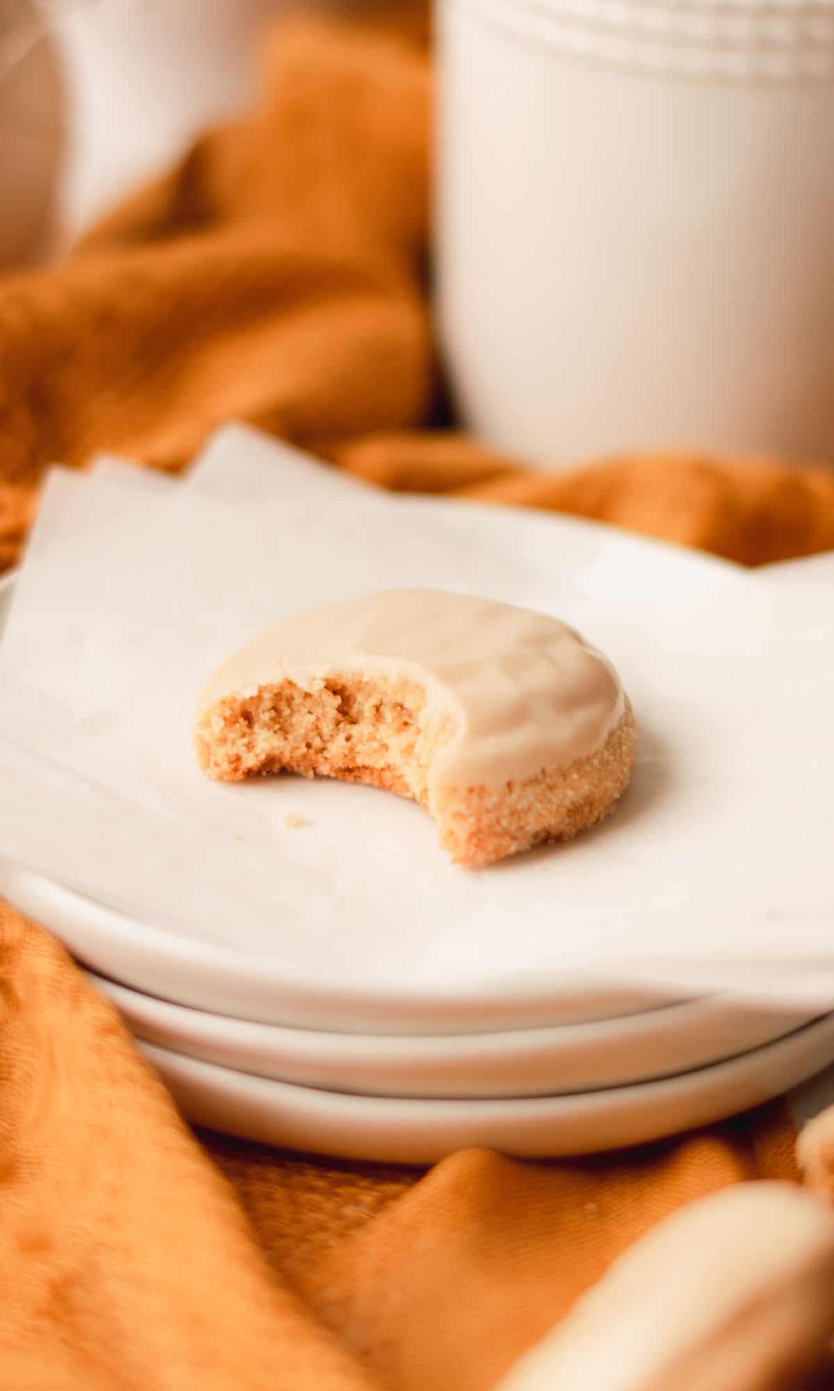A brown butter brown sugar cookie with a bite taken out of it.