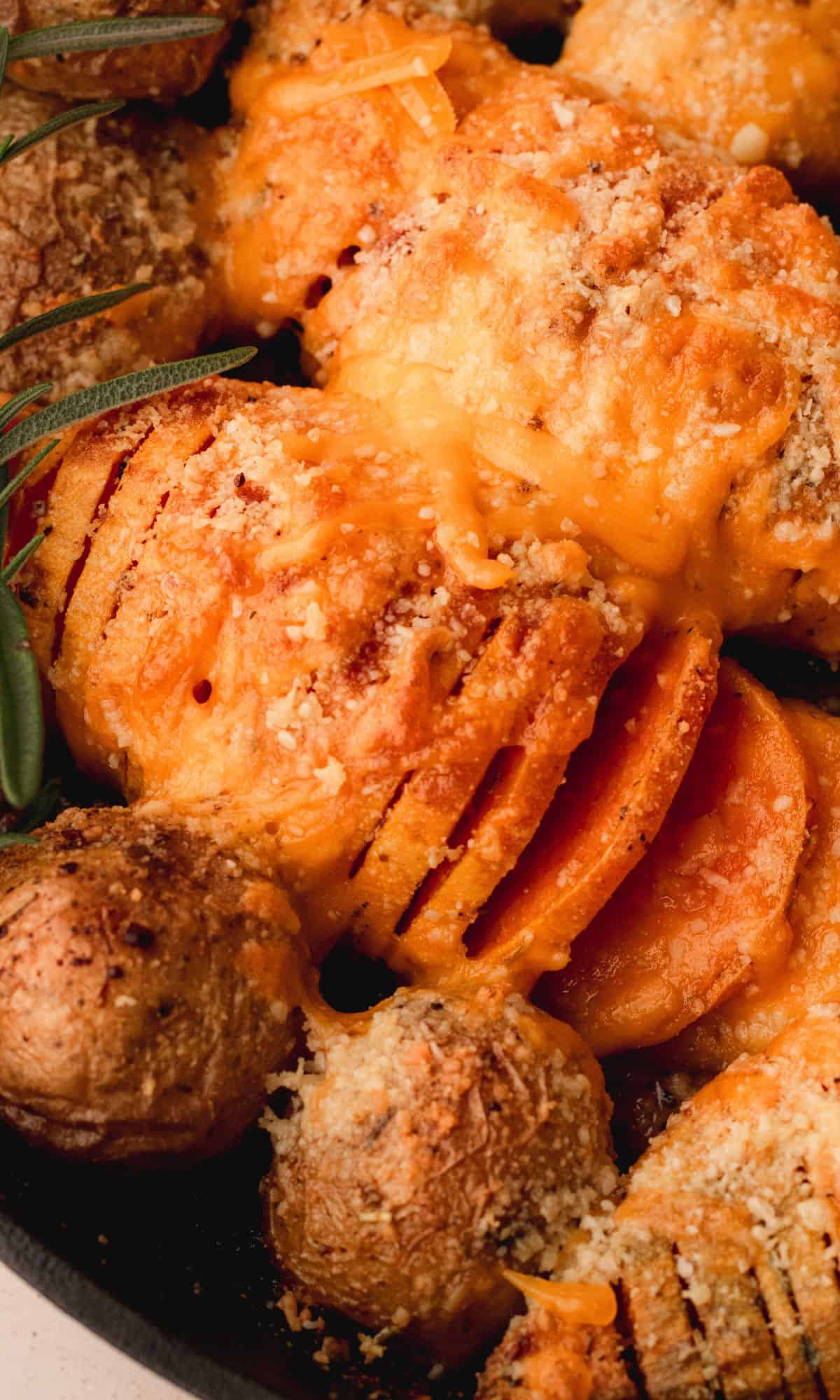 Hasselback sweet potatoes in a cast iron skillet.