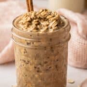 Overnight oats in a mason jar with a cinnamon stick.