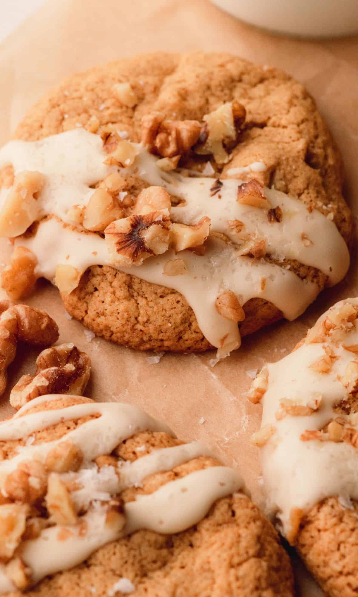 Walnut spice cookies with a maple glaze drizzle and wanuts.