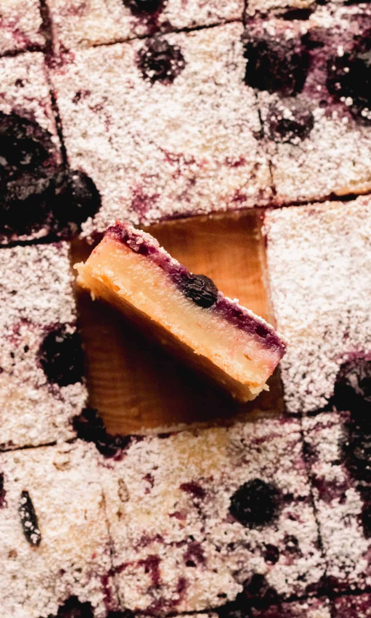 A side view of a blueberry lemon bar.