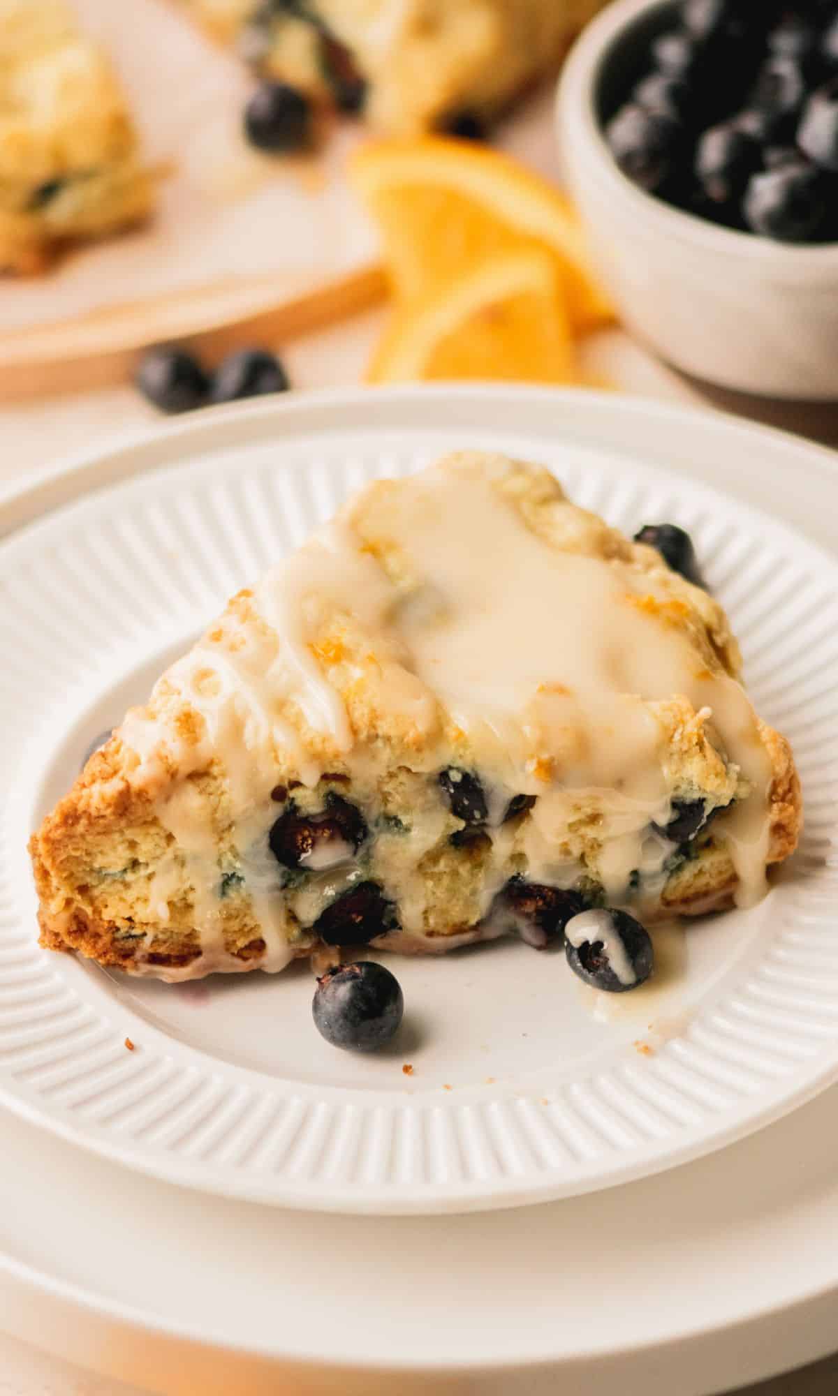 A blueberry scone on a white plate.