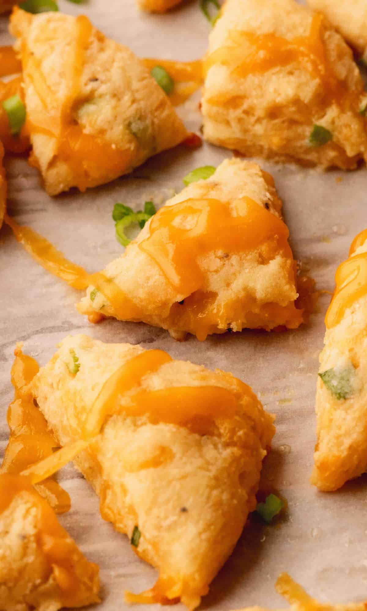 Mini cheddar scones on a baking sheet.