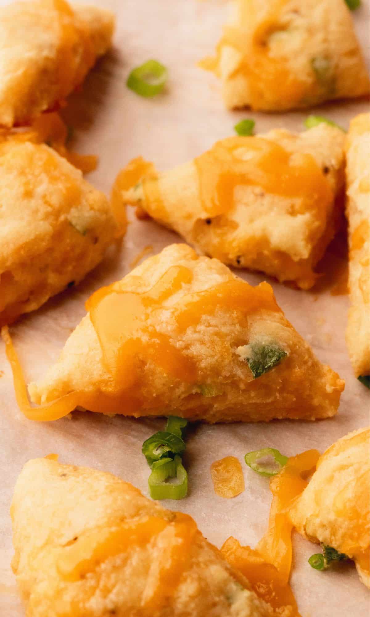 Cheddar scallion scones on a baking sheet.