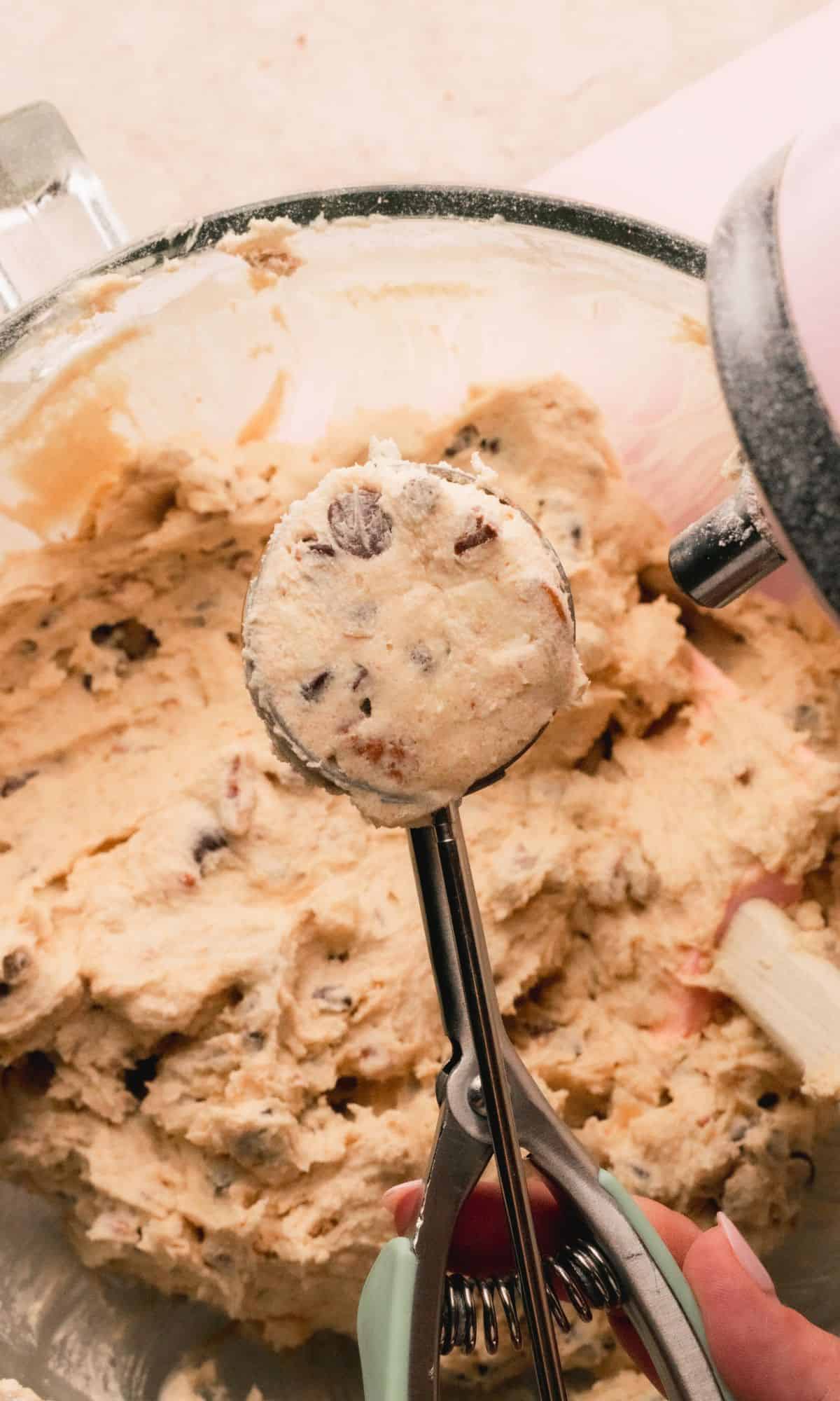 Chocolate chunk cookie dough in a cookie scoop.