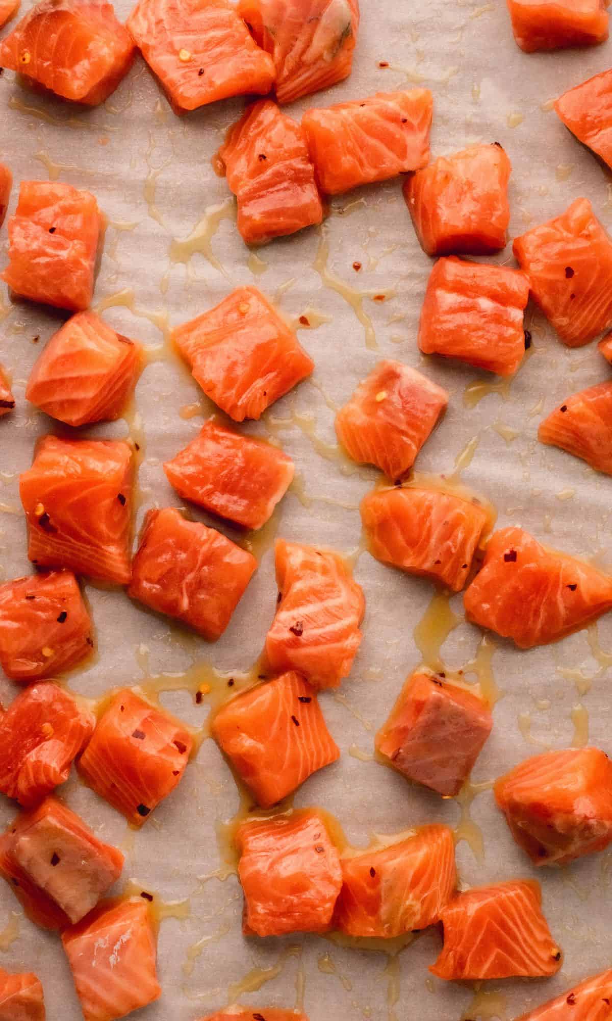 Salmon bites with honey glaze before baking.